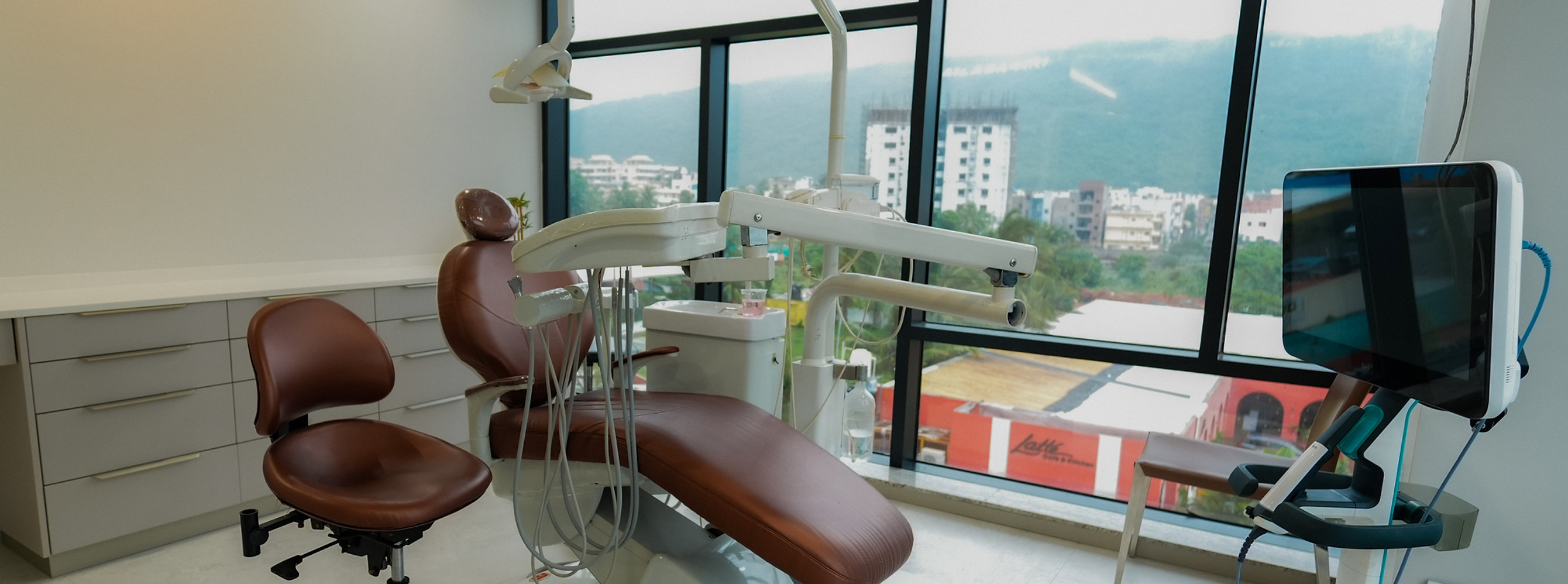 Krest Dental treatment room with dental chair and city view